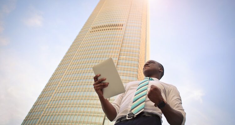 man standing near high-rise building