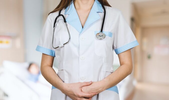 woman in white button up shirt and blue stethoscope