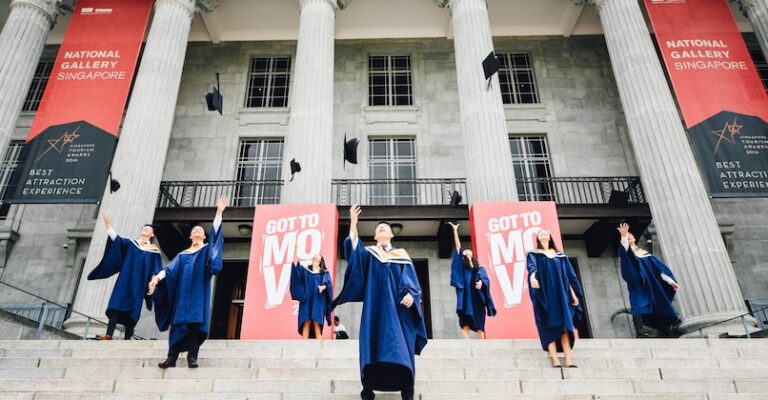 graduates in front of building